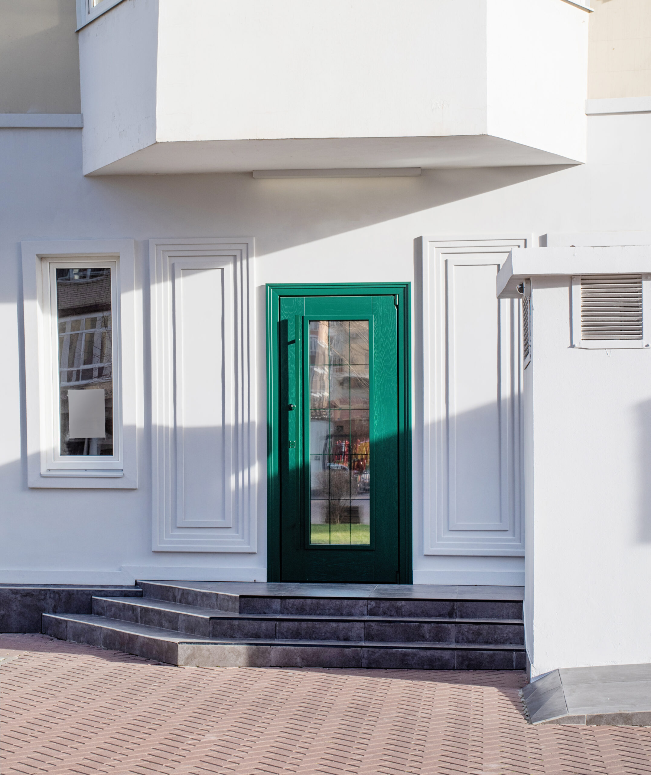 Establishment exterior with white walls and green door, mockup design